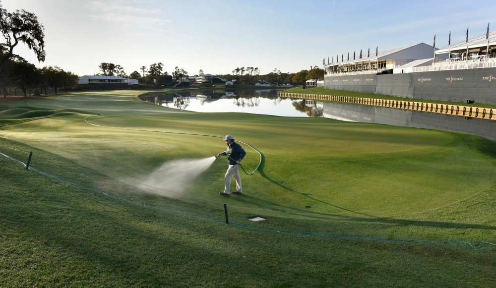 Assistant superintendent JB Workman waters the 18th green after the decision was made to cancel the last three days of The Players Championship because of the coronavirus, March 13, 2020. u00e2u20acu2022 Picture by Will Dickey/Florida Times-Union via USA TODAY NETWOR