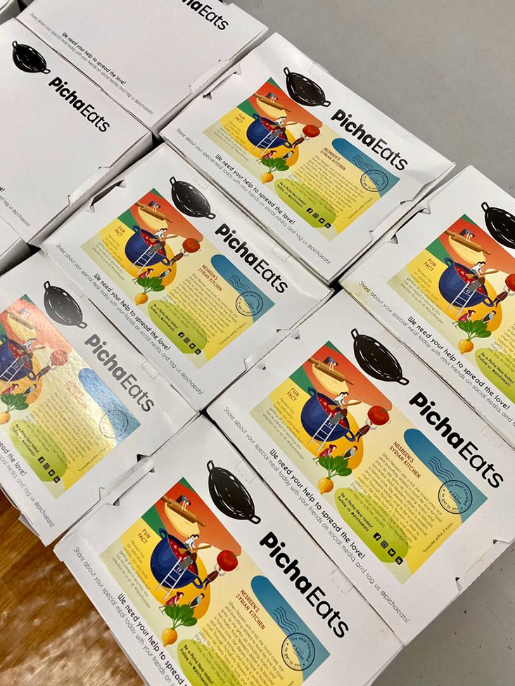 Boxed PichaEats meals made by refugee families from Syria, Afghanistan and other countries.