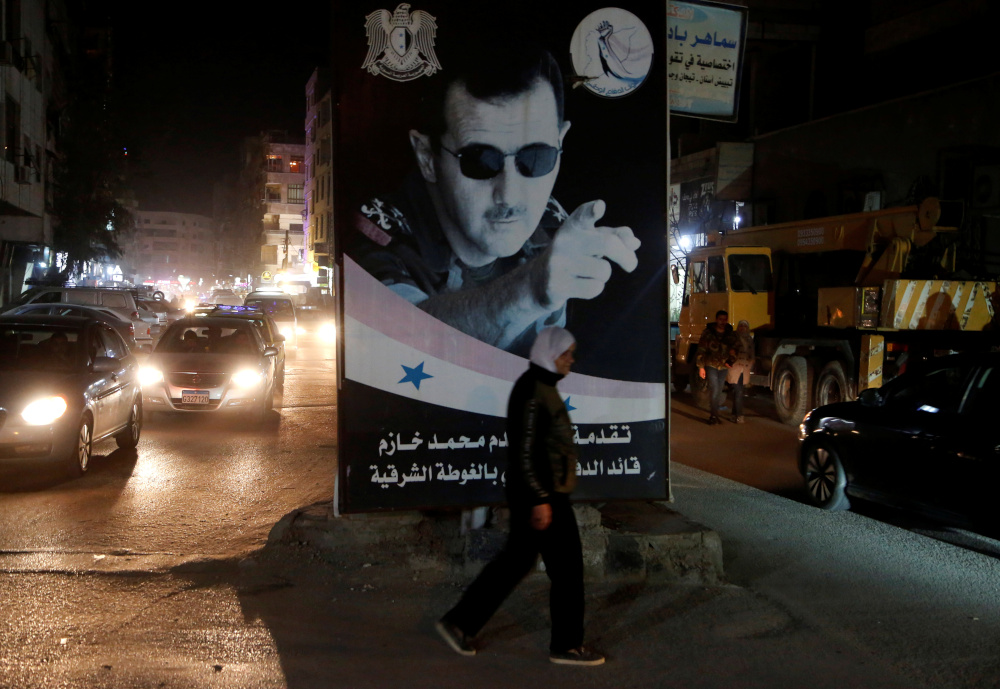 A woman walks past a poster depicting Syriau00e2u20acu2122s President Bashar al-Assad in Damascus, Syria March 5, 2020. u00e2u20acu201d Reuters 