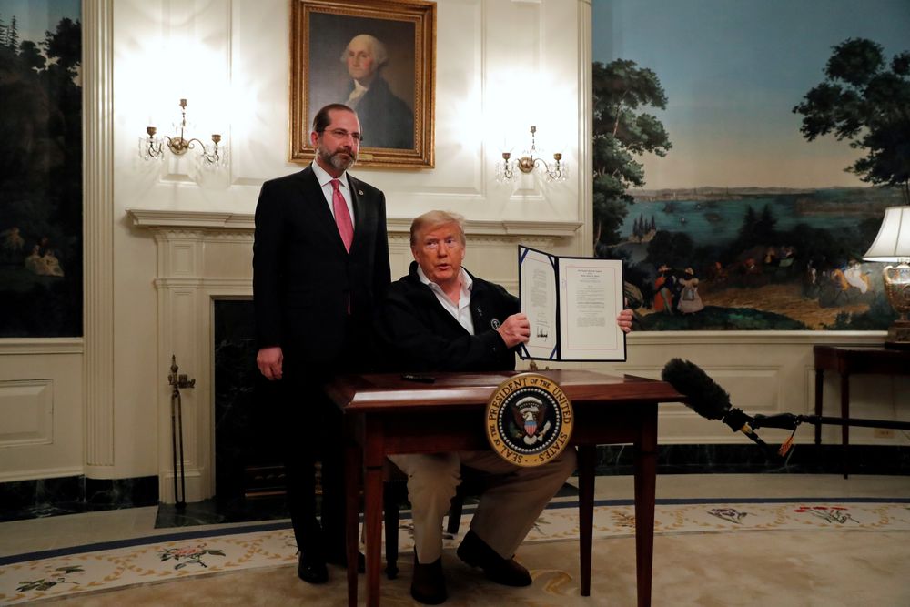US President Donald Trump accompanied by Health and Human Services (HHS) Secretary Alex Azar, presents the signed Congressional funding bill for coronavirus response at the White House in Washington, March 6, 2020. u00e2u20acu201d Reuters pic