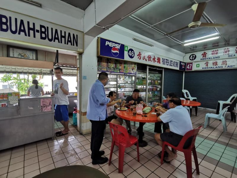 Kuching South City Council mayor Datuk Wee Hong Seng talks to customers having their breakfast at the Kenyalang Park Hawker Centre March 18, 2020. u00e2u20acu201d Picture via Facebook