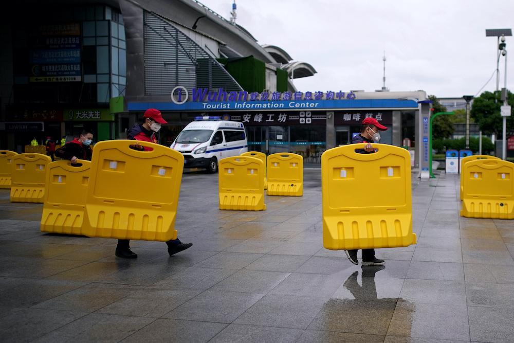 Staff members move barriers in front of a railway station of Wuhan on the first day of inbound train services resumed following the novel coronavirus disease (Covid-19) outbreak, in Wuhan of Hubei province, the epicentre of Chinau00e2u20acu2122s coronavirus outbreak,