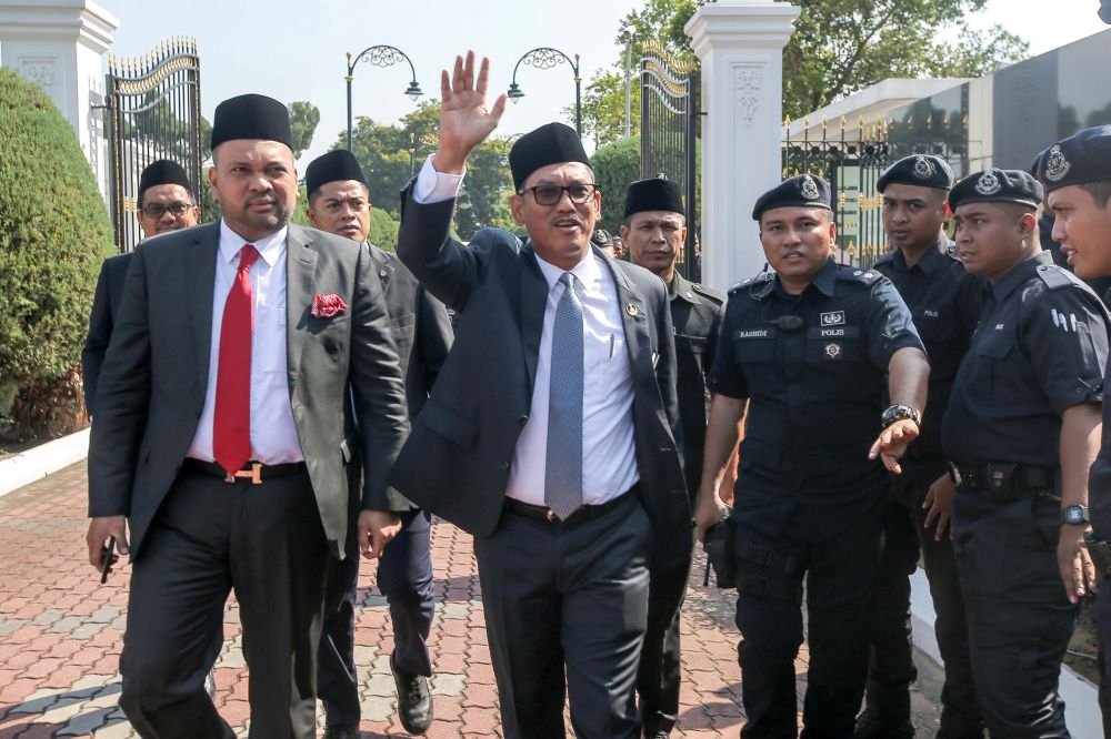 Datuk Seri Ahmad Faizal Azumu waves to reporters at Istana Kinta March 10, 2020. u00e2u20acu201d Picture by Farhan Najib