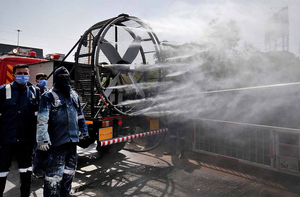 Members of Fire and Emergency Services decontaminate a road in Ahmedabad, India March 22, 2020. u00e2u20acu201d Reuters pic