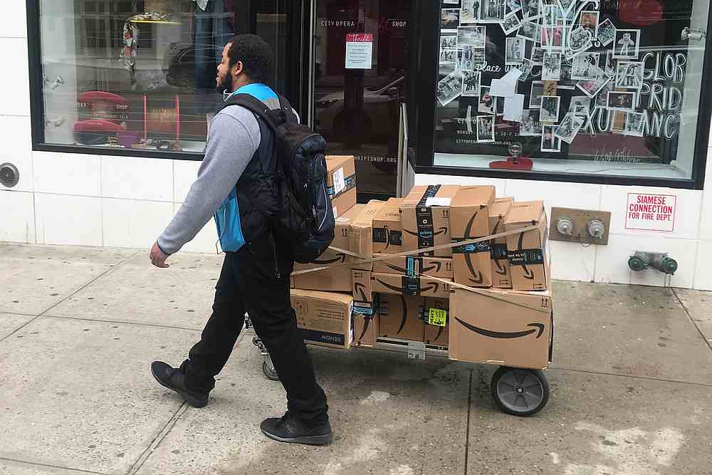 A man delivers Amazon packages following the spread of Coronavirus disease, in New York March 20, 2020. u00e2u20acu201d Reuters pic