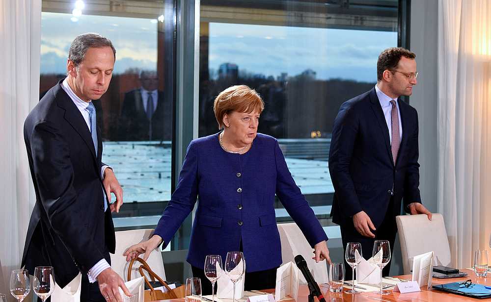 German Chancellor Angela Merkel (centre) arrives for a meeting on the economic consequences of the spread of Covid-19 at the Chancellery in Berlin, Germany March 13, 2020. u00e2u20acu201d John Macdougall/Pool pic via Reuters