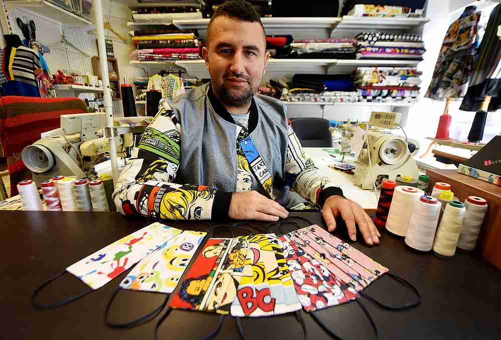 Croatian designer Zoran Aragovic posing next to protective face masks bearing his designs. u00e2u20acu201d AFP pic