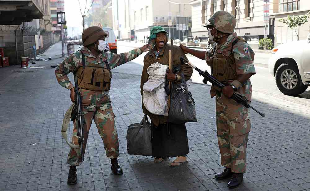 Members of the South African National Defence Force speak to a homeless women during their patrols on the first day of a nationwide lockdown, in Johannesburg March 27, 2020. u00e2u20acu201d Reuters pic