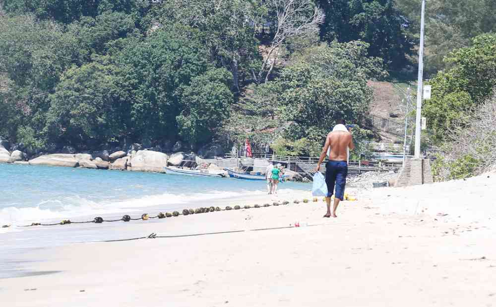 A few tourists are seen walking along the beach in Batu Ferringhi, March 19, 2020. u00e2u20acu2022 Picture by Sayuti Zainudin
