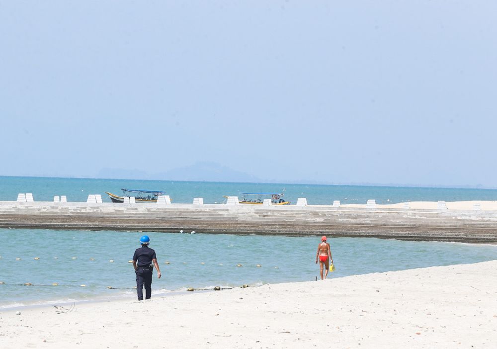 Most parts of the beaches were deserted except for a few tourists suntanning and swimming in the sea.