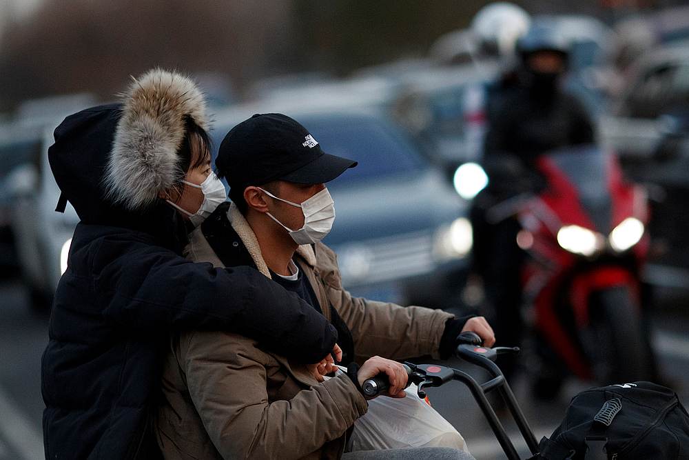 People with face masks in a street in Beijing, China March 11, 2020.u00e2u20acu201d Reuters pic