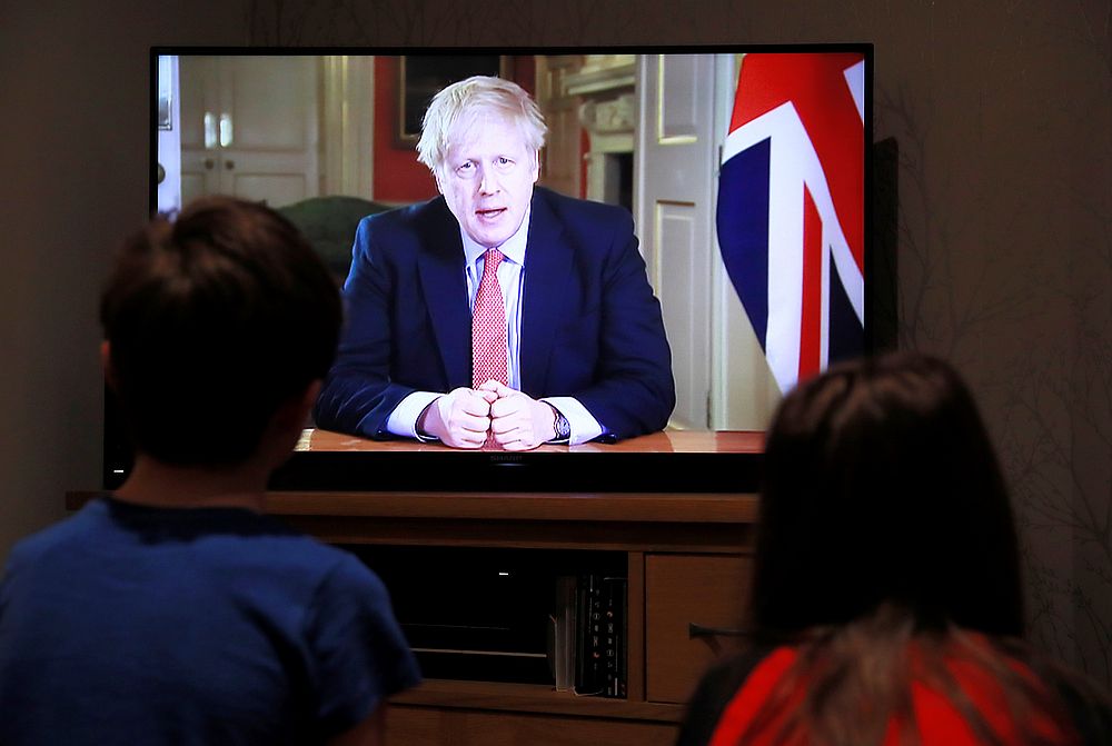 Two children watch British Prime Minister Boris Johnson's press conference as the spread of Covid-19 continues in Hertford, Britain March 23, 2020. u00e2u20acu201d Reuters pic