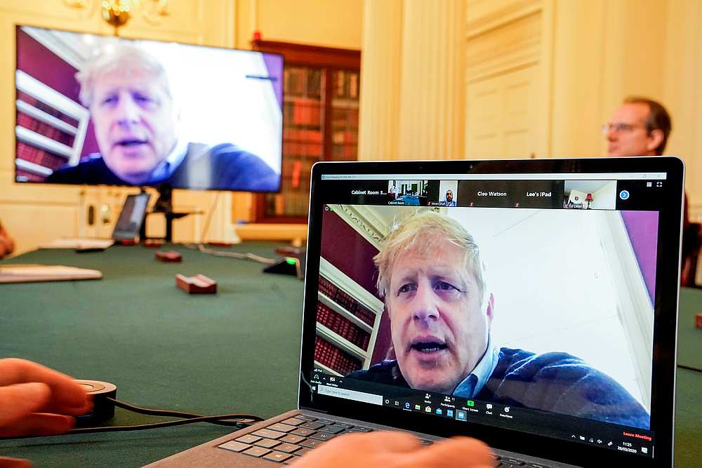 Britain's Prime Minister Boris Johnson appears on monitors for the Covid-19 meeting in London, Britain March 28, 2020. u00e2u20acu201d Andrew Parsons/10 Downing Street handout via Reuters