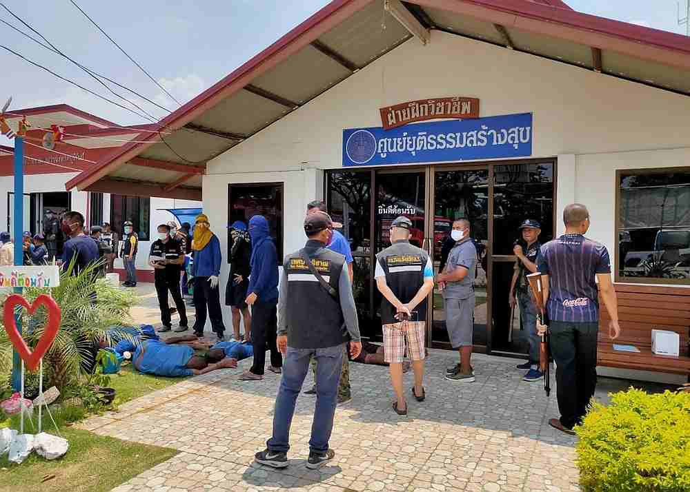 Buriram Prison security personnel looking over a group of inmates on the ground after a jail riot in Buriram, Thailand March 29, 2020. u00e2u20acu201d Thailand Ministry of Justice handout via AFP