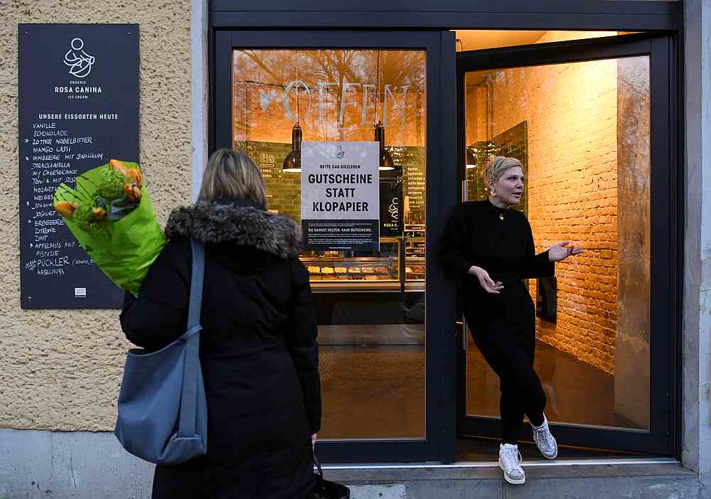 An information sheet for neighbourhood help that reads 'Coupons instead of toilet paper' is displayed at ice cream shop 'Rosa Canina' in Berlin, Germany March 16, 2020. u00e2u20acu201d Reuters pic