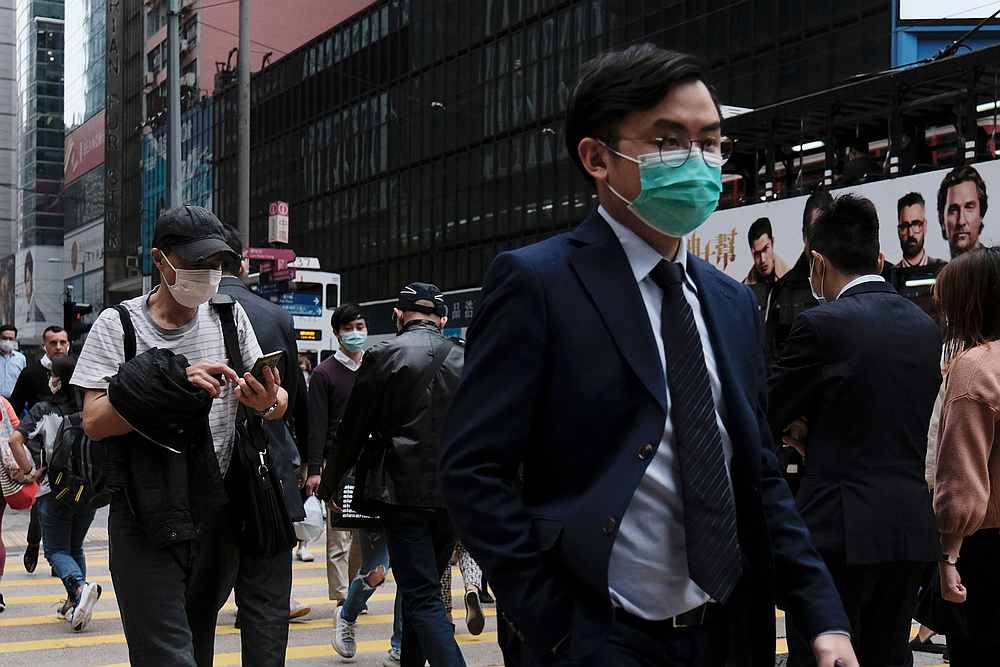 People wear protective face masks during their lunch breaks at the financial Central district in Hong Kong March 2, 2020. u00e2u20acu201d Reuters pic
