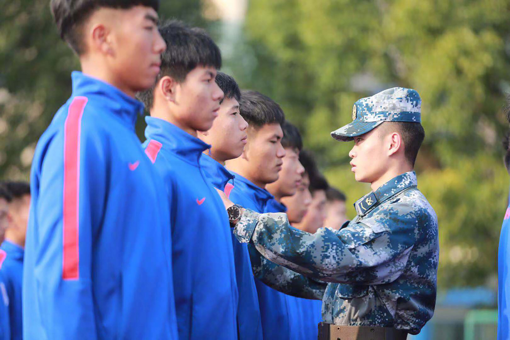 This file picture taken November 29, 2018 shows players being inspected by a soldier during military-style training sessions at the teamu00e2u20acu2122s training ground in Shanghai. u00e2u20acu201d Shanghai Shenhua handout pic via AFP 