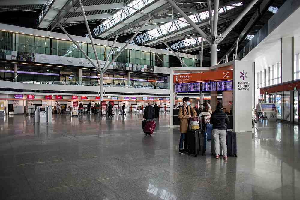 Passangers wearing face masks ar seen at the terminal of Warsaw Chopin Airport following the outbreak of coronavirus disease in Warsaw, Poland, March 13, 2020. u00e2u20acu201d Dawid Zuchowicz/Agencja Gazeta pic via Reuters
