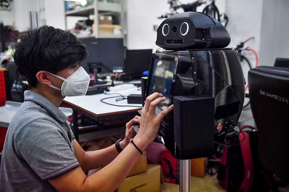 An engineering student configures a medical robot modified to screen and observe Covid-19 patients at Chulalongkorn University in Bangkok March 18, 2020. u00e2u20acu201d AFP pic