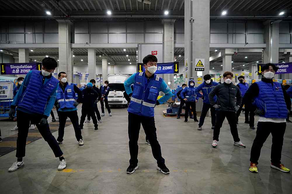 Delivery staff for Coupang Jung Im-hong wearing masks while warming up in Incheon, South Korea, March 3, 2020. u00e2u20acu201d Reuters pic