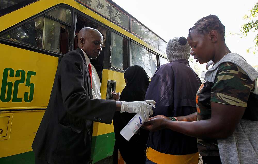 A Citi Hoppa bus staff member provides hand sanitiser to a passenger, as a preventative measure against Covid-19 fears, in downtown Nairobi, Kenya March 16, 2020. u00e2u20acu201d Reuters pic