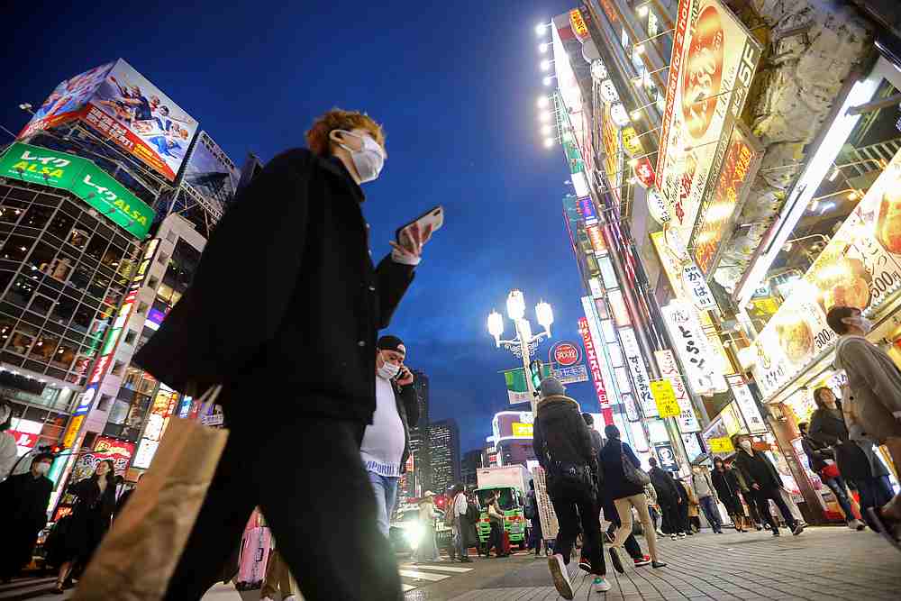 People pass a street wearing protective face masks following an outbreak of Covid-19 in Tokyo, Japan March 9, 2020. u00e2u20acu201d Reuters pic