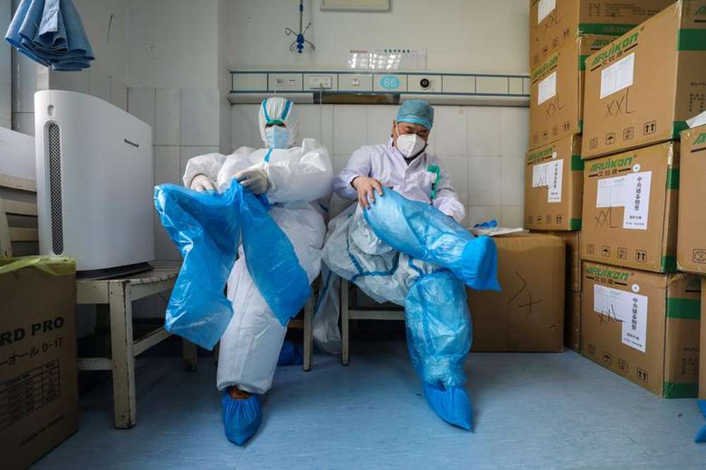 Medical workers put on protective suits at a preparation room next to isolation wards at Wuhan Red Cross Hospital, February 24. u00e2u20acu201d China Daily pic via Reuters
