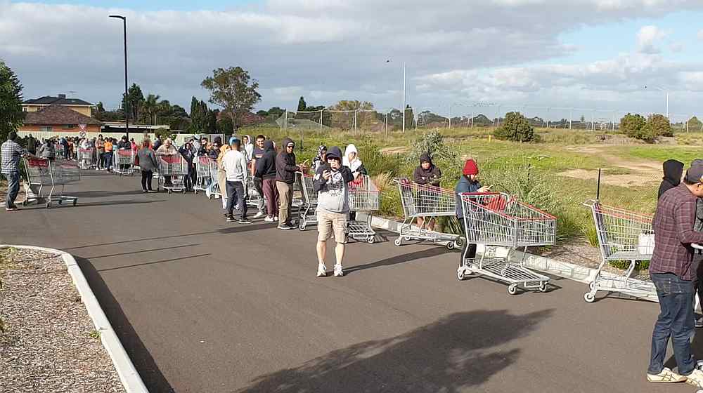 Shoppers line up outside a Costco Wholesale store in Epping, Melbourne, Victoria, Australia March 14, 2020. u00e2u20acu201d Richard Sharman/social media still image via Reuters