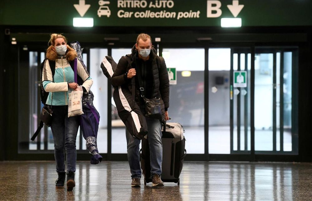 People wearing protective masks walk in Malpensa airport near Milan, Italy, March 9, 2020. u00e2u20acu201d Reuters pic