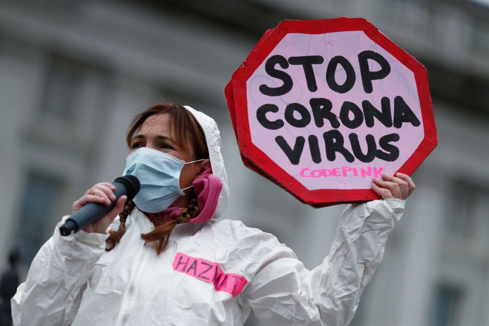 A woman attends a protest against the exacerbation of the coronavirus disease worldwide, as the World Health Organization said for the first time that it now sees the coronavirus outbreak as a pandemic, in Washington March 11, 2020. u00e2u20acu201d Reuters pic