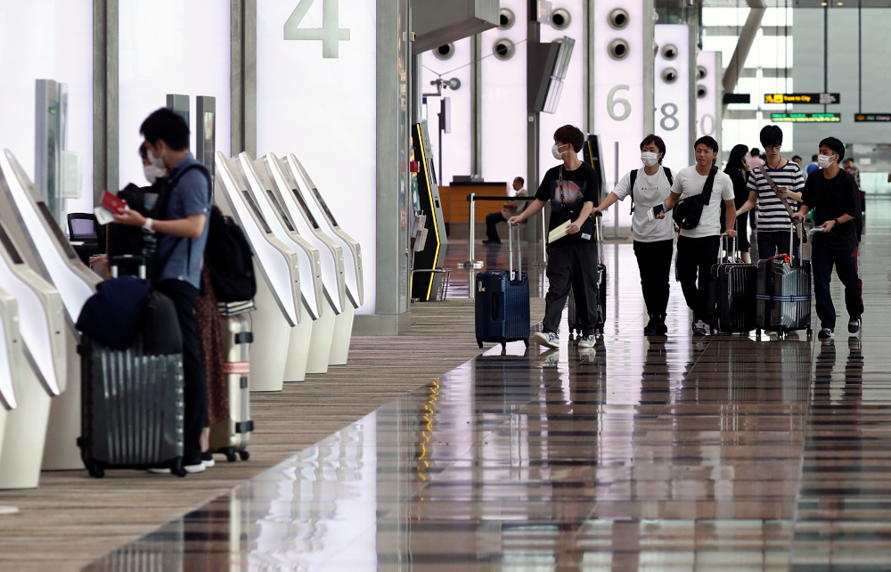 People wearing masks walk in Changi Airport, following the coronavirus outbreak, in Singapore March 5, 2020. u00e2u20acu201d Reuters pic 