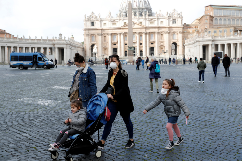 People wear protective face masks on St Peteru00e2u20acu2122s Square after the Vatican reports its first case of coronavirus, at the Vatican, March 6, 2020. u00e2u20acu201d Reuters pic