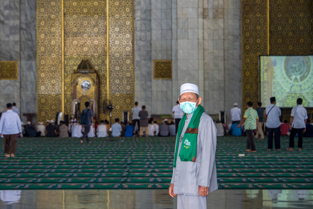 A man wearing a face mask walks inside the Al Akbar mosque before Friday prayer in Surabaya, East Java province March 6, 2020. u00e2u20acu201d AFP pic 