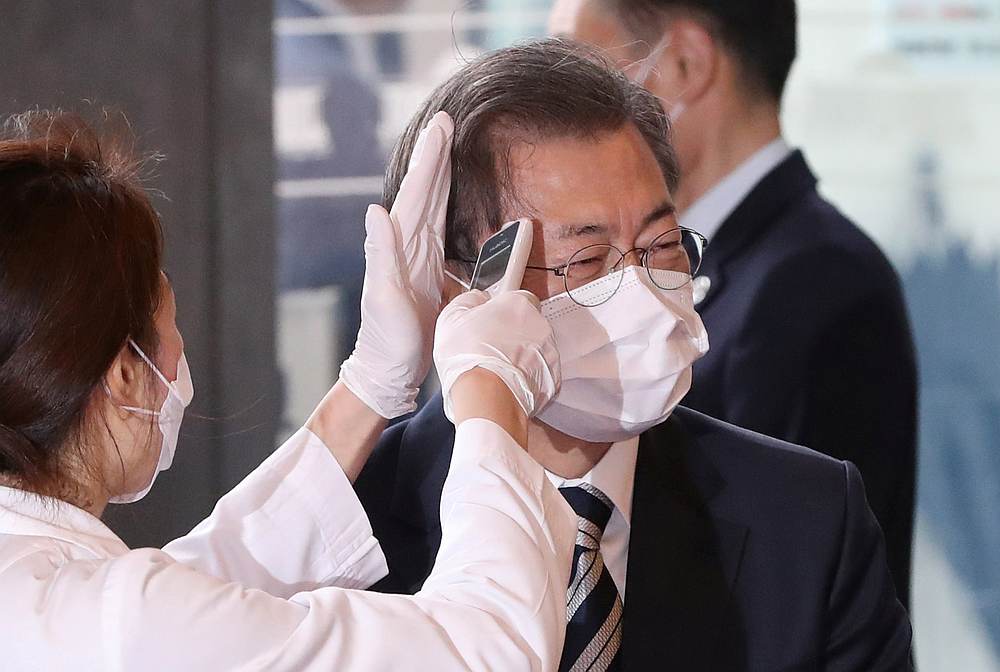 South Korean President Moon Jae-in gets temperature tested upon his arrival at the National Assembly in Seoul, South Korea,February 28, 2020. u00e2u20acu201d Yonhap pic via Reuters