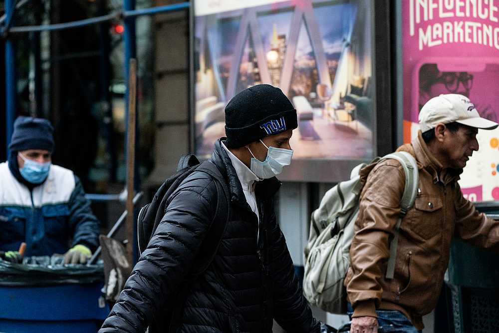 A man wearing a protective mask is seen following the outbreak of Covid-19, in New York March 16, 2020. u00e2u20acu201d Reuters pic