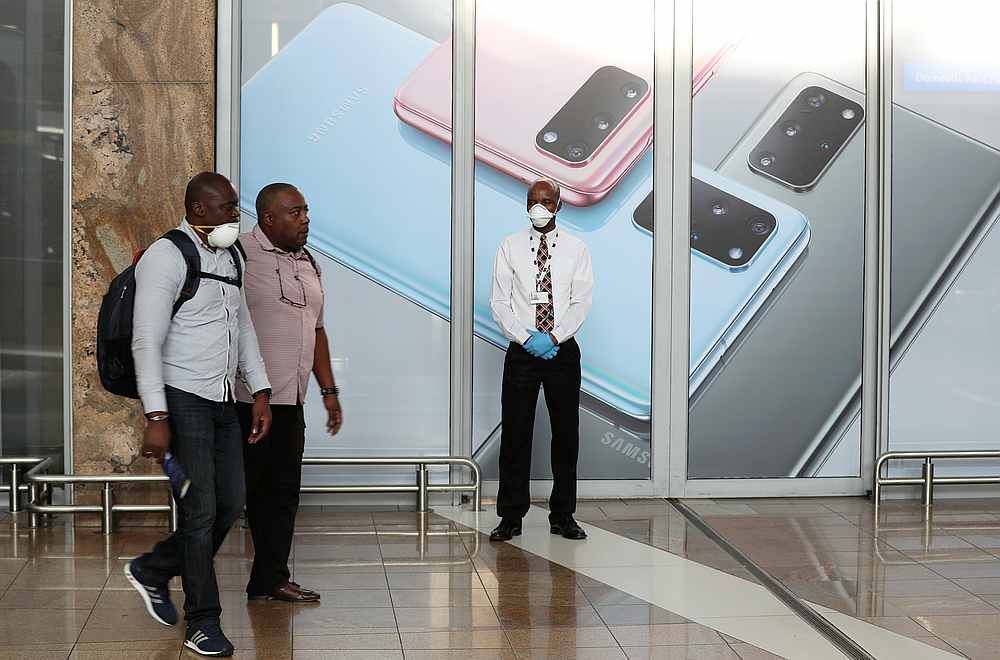 An airport worker in a protective mask looks on as travellers arrive at the OR Tambo International Airport in Kempton Park, South Africa March 12, 2020. u00e2u20acu201d Reuters pic
