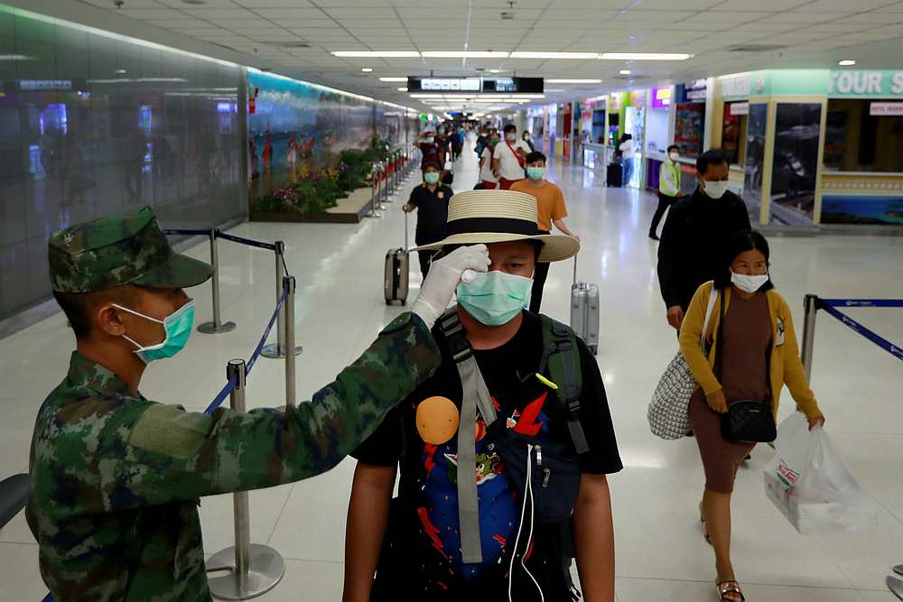 A passenger has his temperature checked due to the Covid-19 outbreak as he arrives at Phuket airport, Thailand March 9, 2020. u00e2u20acu201d Reuters pic