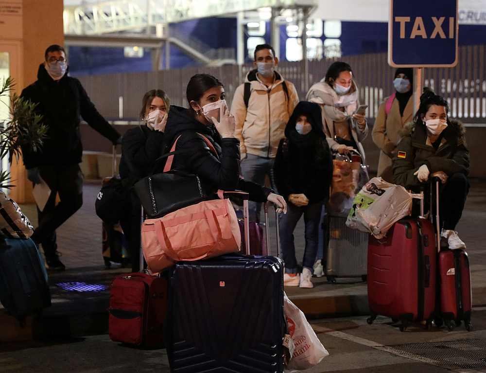 Passengers are seen after disembarking as Cruise Roma Ferry with 200 Spaniards on board at Barcelona Spain March 25, 2020. u00e2u20acu201d Reuters pic