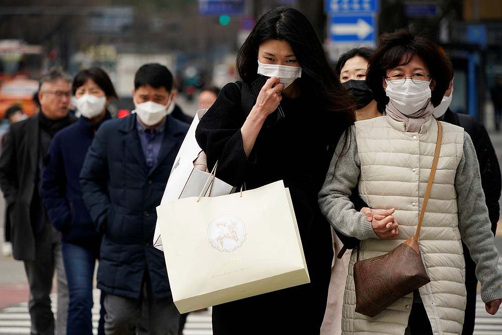 Pedestrians wearing masks to prevent contracting the coronavirus walk on a zebra crossing in Seoul, South Korea, March 12, 2020. u00e2u20acu201d Reuters pic
