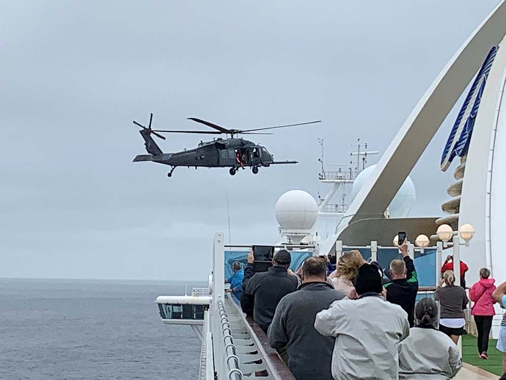 Passengers on board the Grand Princess cruise ship watch while a US military helicopter hovers above the deck as the ship approaches San Francisco, California. u00e2u20acu201d Steve Berry handout via Reuters