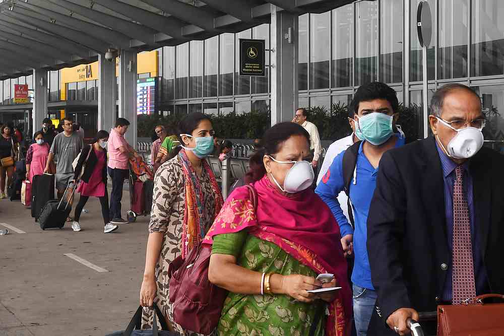 Passengers wearing facemasks as a preventive measure against the spread of the Covid-19 outbreak at Netaji Subhas Chandra Bose International Airport in Kolkata March 7, 2020. u00e2u20acu201d AFP pic