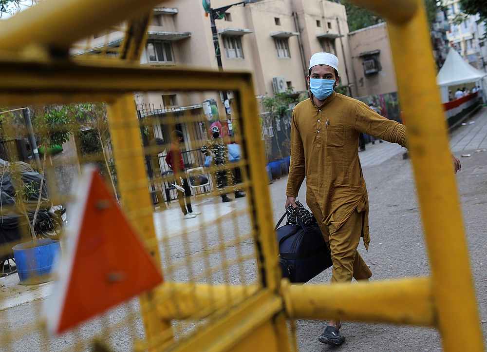 A man wearing a protective mask walks to board a bus that will take him to a quarantine facility in Nizamuddin area of New Delhi, India March 30, 2020. u00e2u20acu201d  Reuters pic
