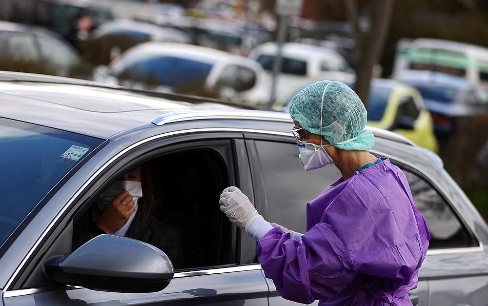 Doctor Roxana Sauer looks into a car as she prepares a test kit for a Covid-19 test at a drive-in coronavirus check at the hospital of Gross-Gerau, Germany March 9, 2020. u00e2u20acu201d Reuters pic