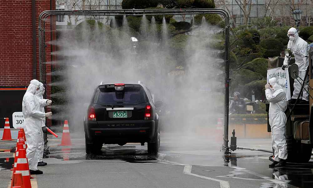 South Korean soldiers in protective gear use a machine to spray disinfectant on visiting cars at Kyungpook National University Hospital in Daegu, South Korea March 3, 2020. u00e2u20acu201d Reuters pic