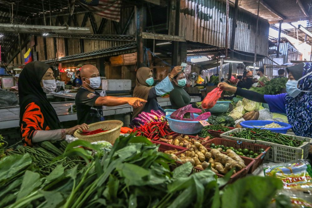 Customers observe social distancing guidelines as they do their shopping at the Datuk Keramat wet market in Kuala Lumpur March 26, 2020. u00e2u20acu201d Picture by Firdaus Latif