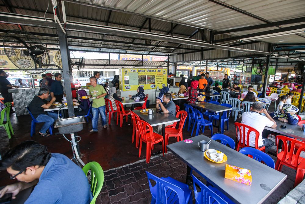 Patrons are pictured at the Nasi Ayam Warisan eatery in Kota Damansara March 17, 2020. — Picture by Hari Anggara
