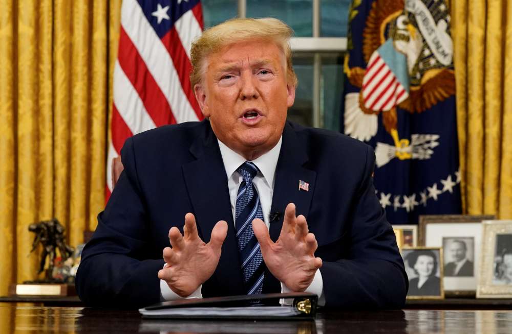 Donald Trump speaks about the US response to the Covid-19 coronavirus pandemic during an address to the nation from the Oval Office of the White House in Washington March 11, 2020. u00e2u20acu2022 Reuters pic