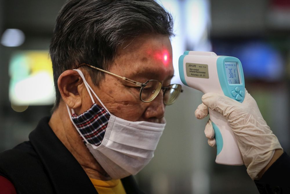 Personnel from the Emergency Response Team screen members of the public at KL Sentral March 20, 2020. u00e2u20acu2022 Picture by Yusof Mat isa