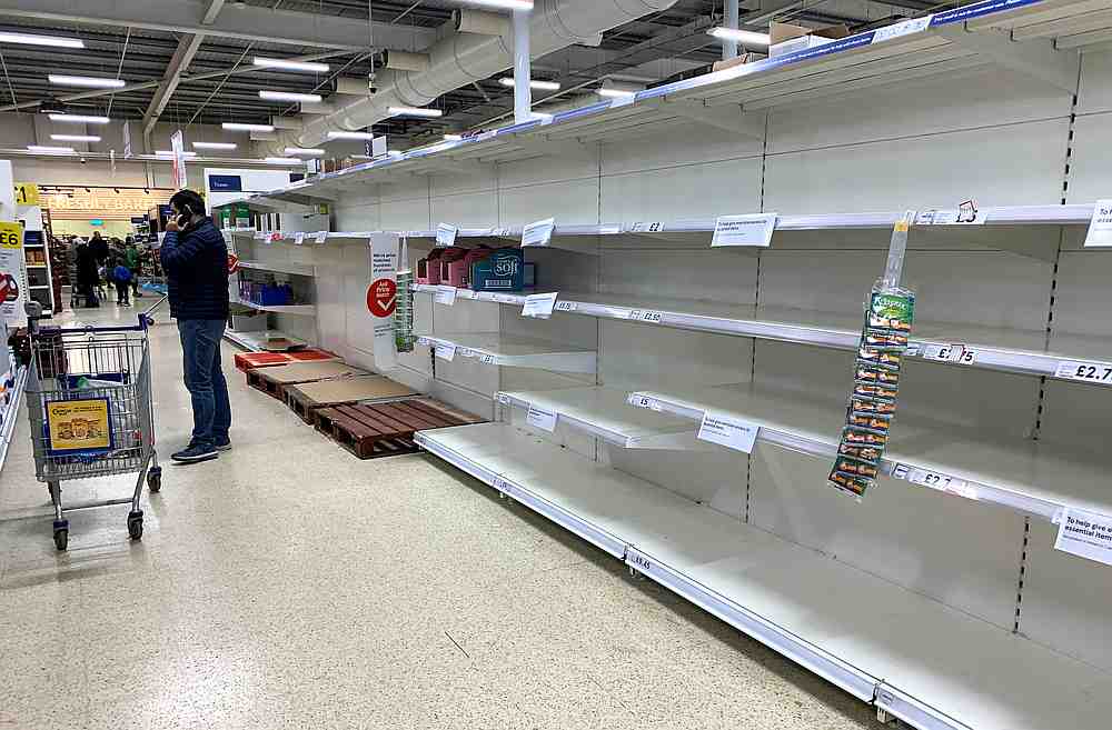 A man talks on his phone as he stands at an empty toilet roll aisle in a Tesco supermarket in Manchester, Britain March 14, 2020. u00e2u20acu201d Reuters pic