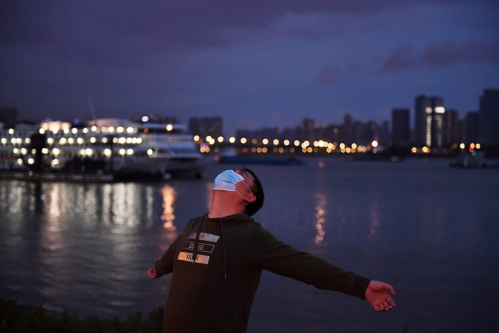 A man wearing a face mask exercises at a riverside park by the Yangtze River in Wuhan of Hubei province, China March 26, 2020. u00e2u20acu201d Reuters pic